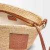 Pochette-Tasche „Slit“ aus Raffia und Kalbsleder Pochette-Tasche „Slit“ aus Raffia und Kalbsleder